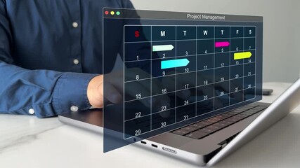 Project manager updating tasks and milestones progress planning with calendar interface for company.Business Project Management System.	 - Powered by Adobe