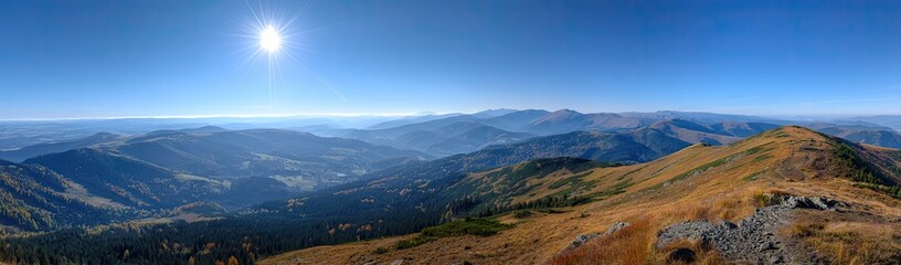 Panoramic mountain vista, sunlit ridges and valleys