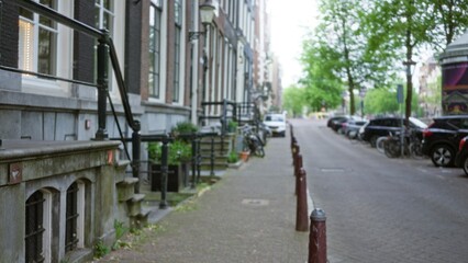 Blurred view of a european city street lined with trees and parked bicycles creating a serene urban...
