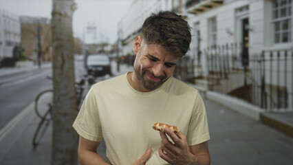 Man holding fresh waffle on urban street while examining its crispy texture and syrup drip; hunger craving flavor.