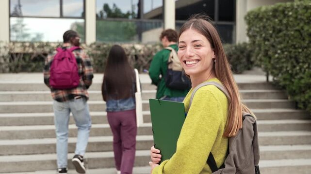 Cheerful blond College student walking going to University