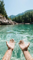 Serene mountain lake with crystal-clear water and outstretched hands