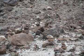 Neatly stacked stone cairns in the remote Himalayan wilderness of Ladakh, India. Traditional cairns symbolize guidance, meditation, and spirituality, set against rugged mountain landscapes. 