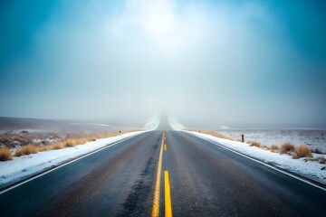 Long Asphalt Road Through Snowy Foggy Landscape