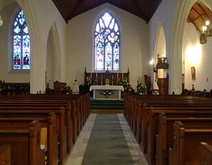 Church sanctuary interior with stained glass