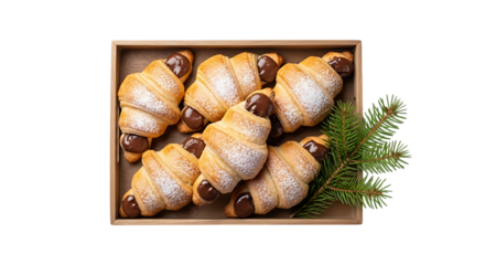 Delicious chocolate filled croissants arranged in a wooden box with greenery isolated on transparent background