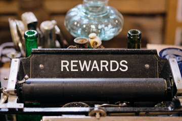 Recognition of successes. Promotion Concept. REWARDS word written on Antique typewriter machine