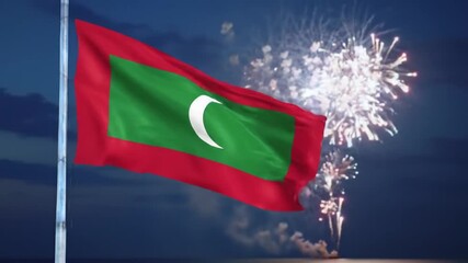 A national flag of the Maldives waving in the night sky, with a backdrop of vibrant fireworks.