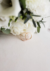 Luxury wedding rings near flowers