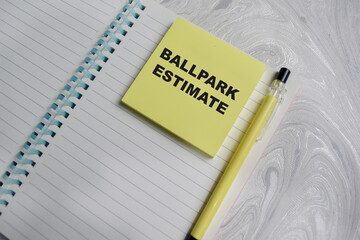 Concept of ballpark estimated write on sticky notes isolated on Wooden Table.