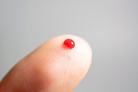 A close-up shot of a diabetes testing pen with its needle tip exposed, set against a neutral, light gray background.