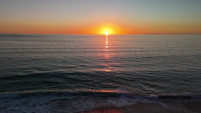 Port Willunga Beach, South Australia: 4K Aerial Drone Footage of Golden Sand Beach at Sunset with Golden Sky, Calm Ocean Waves
