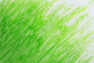 Abstract green paint streaks diagonally across a white background creating a dynamic and energetic texture