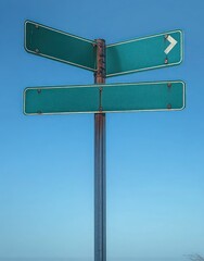 Blank green directional road signs on a metal pole against a clear blue sky with one sign showing a right turn arrow