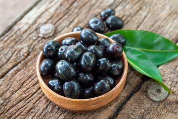 Jambolan plum, Java plum, Jambul( Syzygium cumini (L.) Skeels. on wooden background