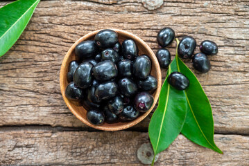 Jambolan plum, Java plum, Jambul( Syzygium cumini (L.) Skeels. on wooden background