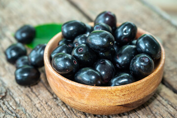 Jambolan plum, Java plum, Jambul( Syzygium cumini (L.) Skeels. on wooden background