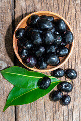 Jambolan plum, Java plum, Jambul( Syzygium cumini (L.) Skeels. on wooden background