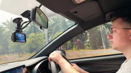 Man driving a car on a sunny day, interior view during a road trip in Thailand. - Powered by Adobe