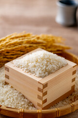 Japanese Rice in a Masu Box

A close-up of Japanese white rice in a traditional wooden masu box, with golden rice stalks in the background. This image captures the freshness and tradition of Japanese 