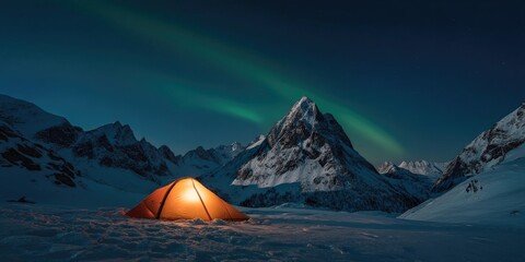 A wide angle landscape of a solitary tent glowing warmly beneath a vivid green aurora in a remote snowy mountain valley, crystal clear night sky filled with stars, peaceful wilderness