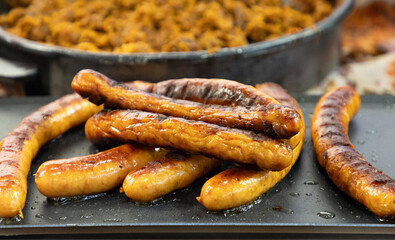 fresh juicy toasted German sausages lie on the grill, ready to eat.