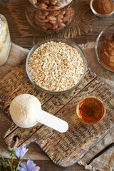 Whey protein powder, oat flakes, nut butter, cinnamon and maple syrup - ingredients for homemade protein bars