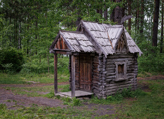 Fairytale wooden house in a summer forest.