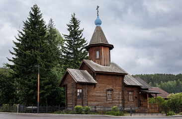 Old wooden church against the sky. Wooden church against the background of nature.