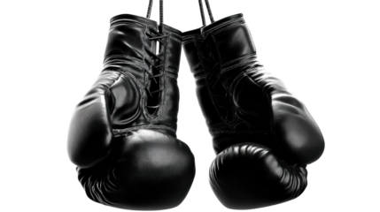 Pair of black leather boxing gloves suspended by ropes against a plain background, cut out transparent