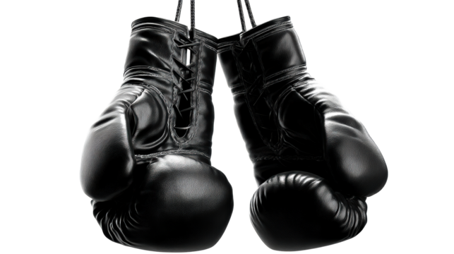 Pair of black leather boxing gloves suspended by ropes against a plain background, cut out transparent - Powered by Adobe