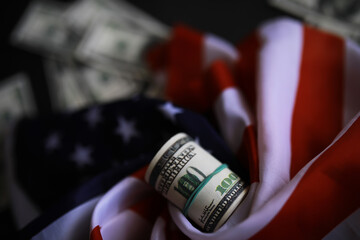 American Flag with Rolled Hundred Dollar Bill - Symbol of Patriotism and Economic Strength