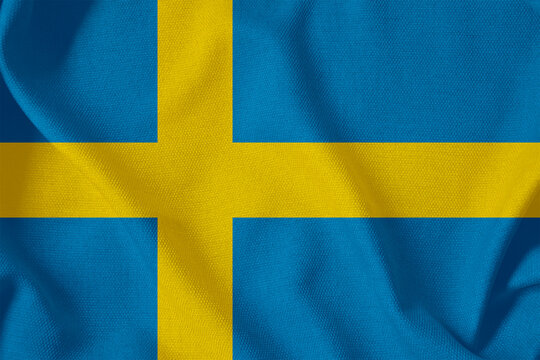 blue flag of the Kingdom of Sweden with a yellow Scandinavian cross on a rough canvas with folds