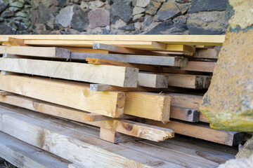 Close-up of Stacked Wood and a Stone Wall