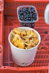 Fresh Chanterelle Mushrooms and Blueberries at a Local Market