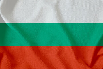 flag of the Republic of Bulgaria with three horizontal stripes on a rough canvas with folds