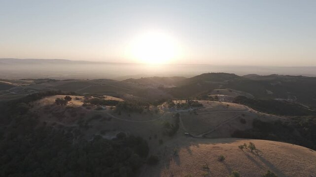 RAW Ungraded Sunset Drone Flyover of Paso Robles Rolling Hills & Oak Woodlands, Central Coast California &mdash; Golden Hour Aerial over Ranch Roads, Vineyards, Valleys & Distant Haze