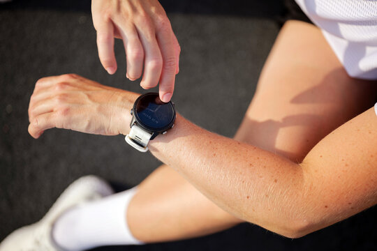 Wearing a fitness watch while tracking performance during outdoor training session