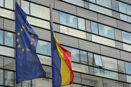 The national flag of Romania and the EU flag side by side.