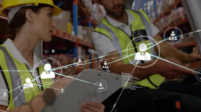 Some warehouse workers are working together in a warehouse