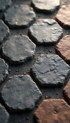 Close-up view of textured hexagonal stone tiles in grey and earthy brown tones. The geometric pattern offers a modern design for interior decor, home improvement, and architectural construction.