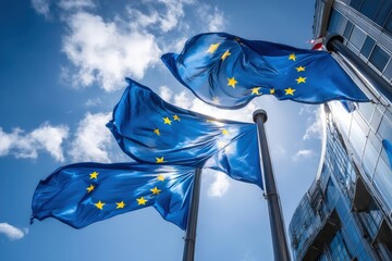 European Union flags waving against a blue sky, symbolizing unity and cooperation among member states.