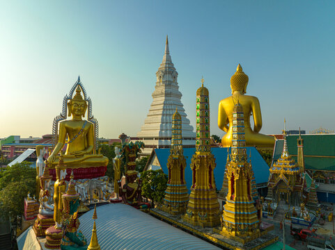 
aerial view golden big Buddha Wat Paknam Phasi Charoen in sunset. 
beautiful sunset reflection on a canal in front big buddha. scenery sky in twilight background.the one famous landmarks in Thailand.