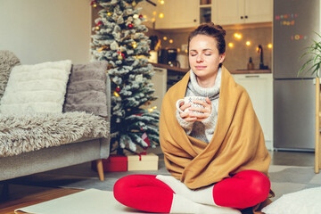woman enjoying hot drink at home during Christmas
