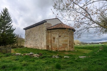 Obraz premium Romanesque hermitage of San Pelayo surrounded by green fields in Olmos de Ojeda