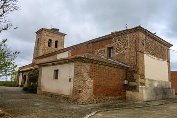 Obraz premium Church of Santa Ines in Villambroz, Palencia, with brick and stone bell tower