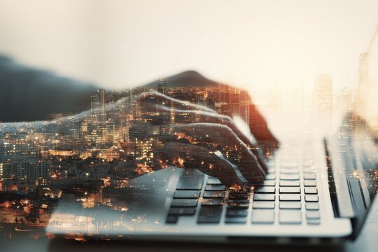 Typing on laptop with vibrant cityscape overlay at dusk showcasing urban life and technology connection