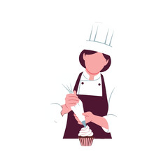 A female chef in a professional uniform decorates a cupcake with a piping bag.