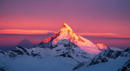 Majestic snow-covered mountain peak at sunset with glowing sky in pink and purple tones, breathtaking adventure landscape.