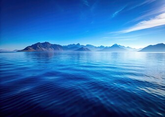 Fototapeta premium Ocean landscape with a vast blue body of water and surrounding mountains